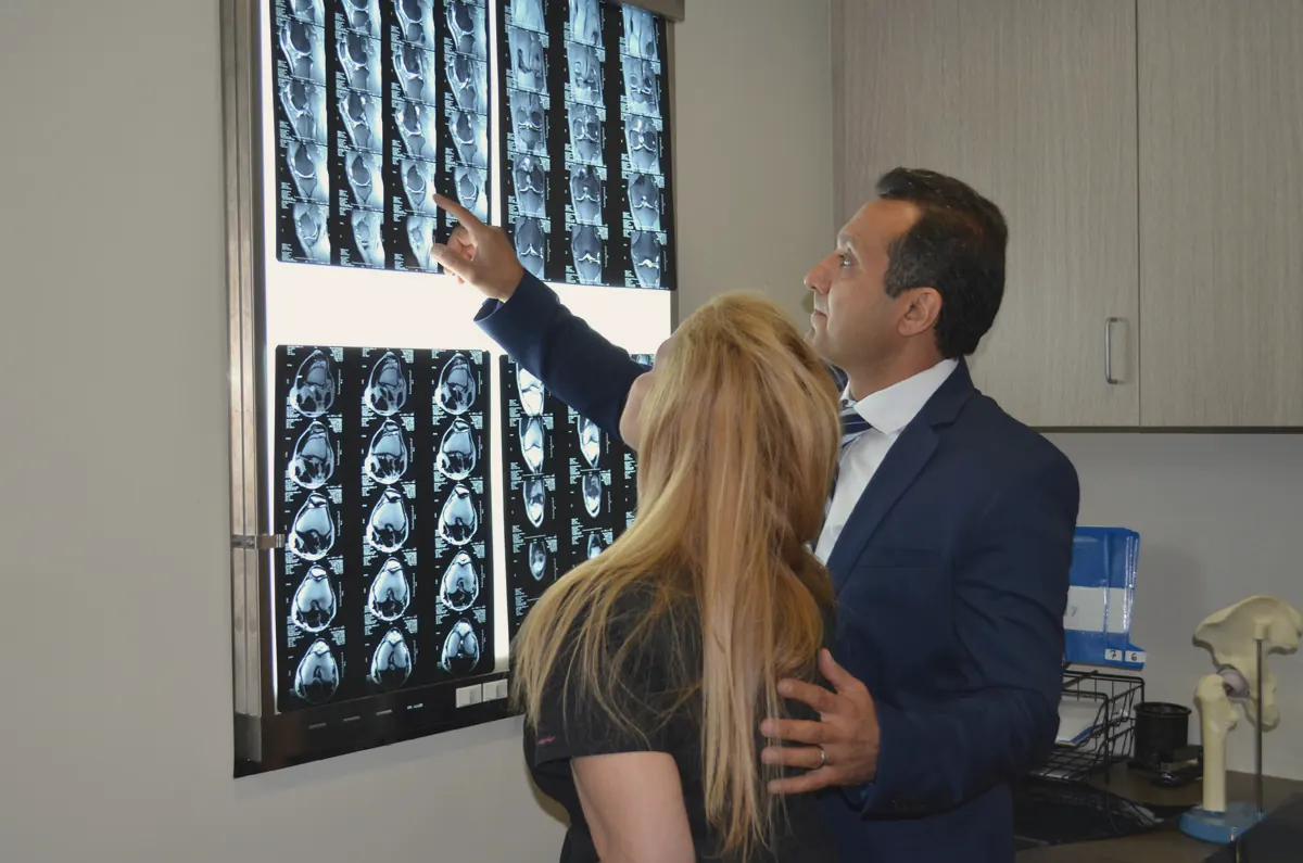 A physician reviewing MRI images with a patient in the practice