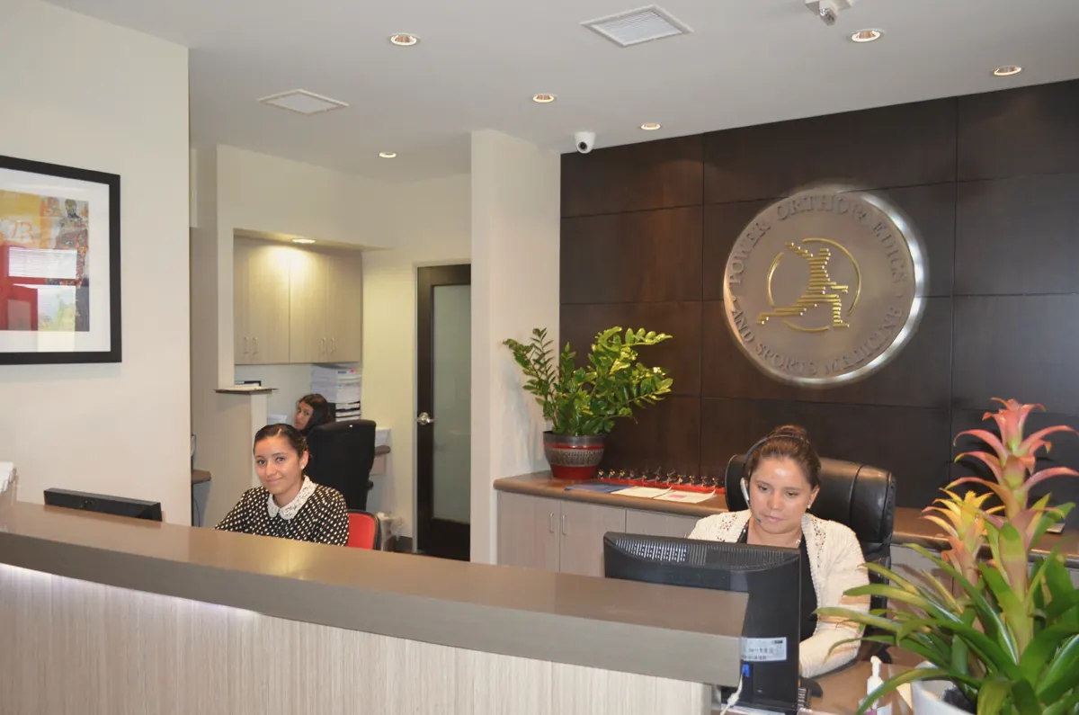 Front desk with the practice emblem on the wall