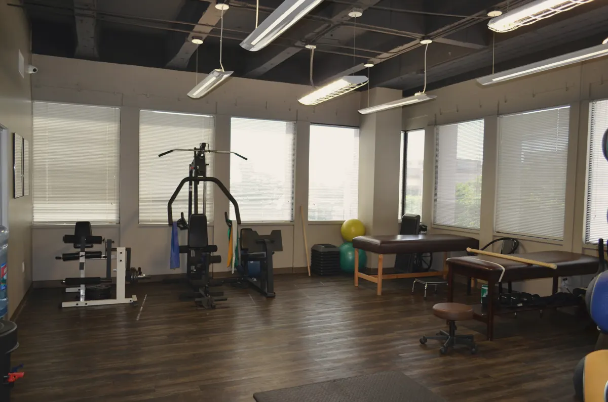 Bright rehabilitation room with exercise equipment